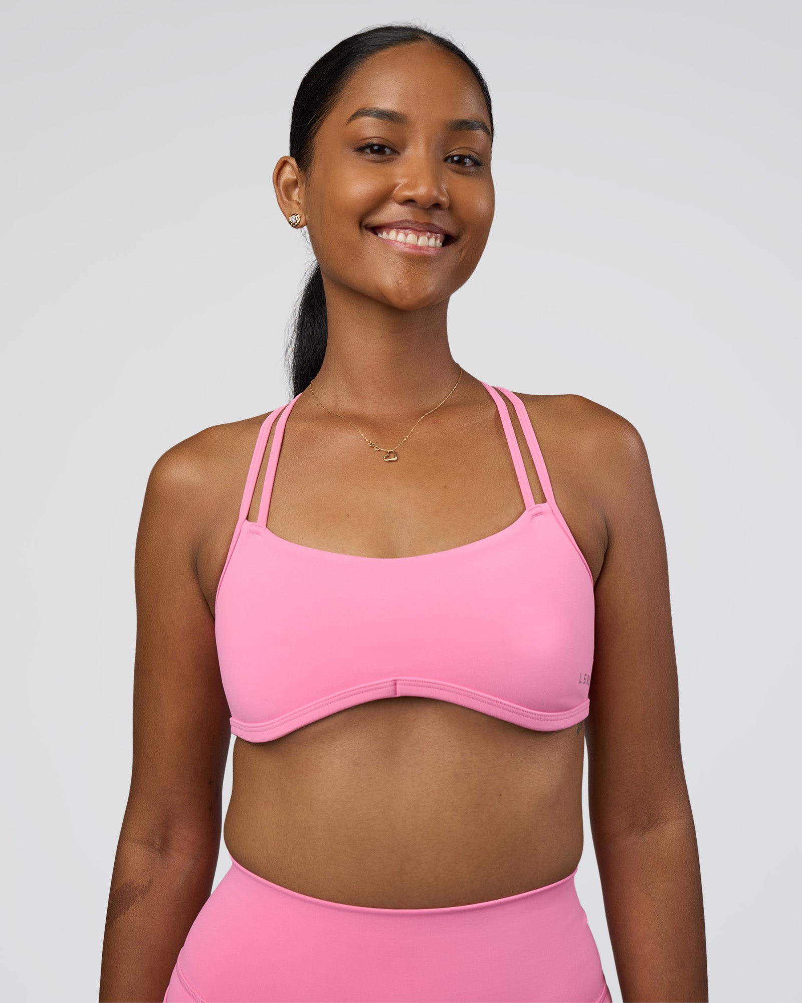 Woman wearing Interstellar Sports Bra - Candy Pink | Model:Rica | Size:S