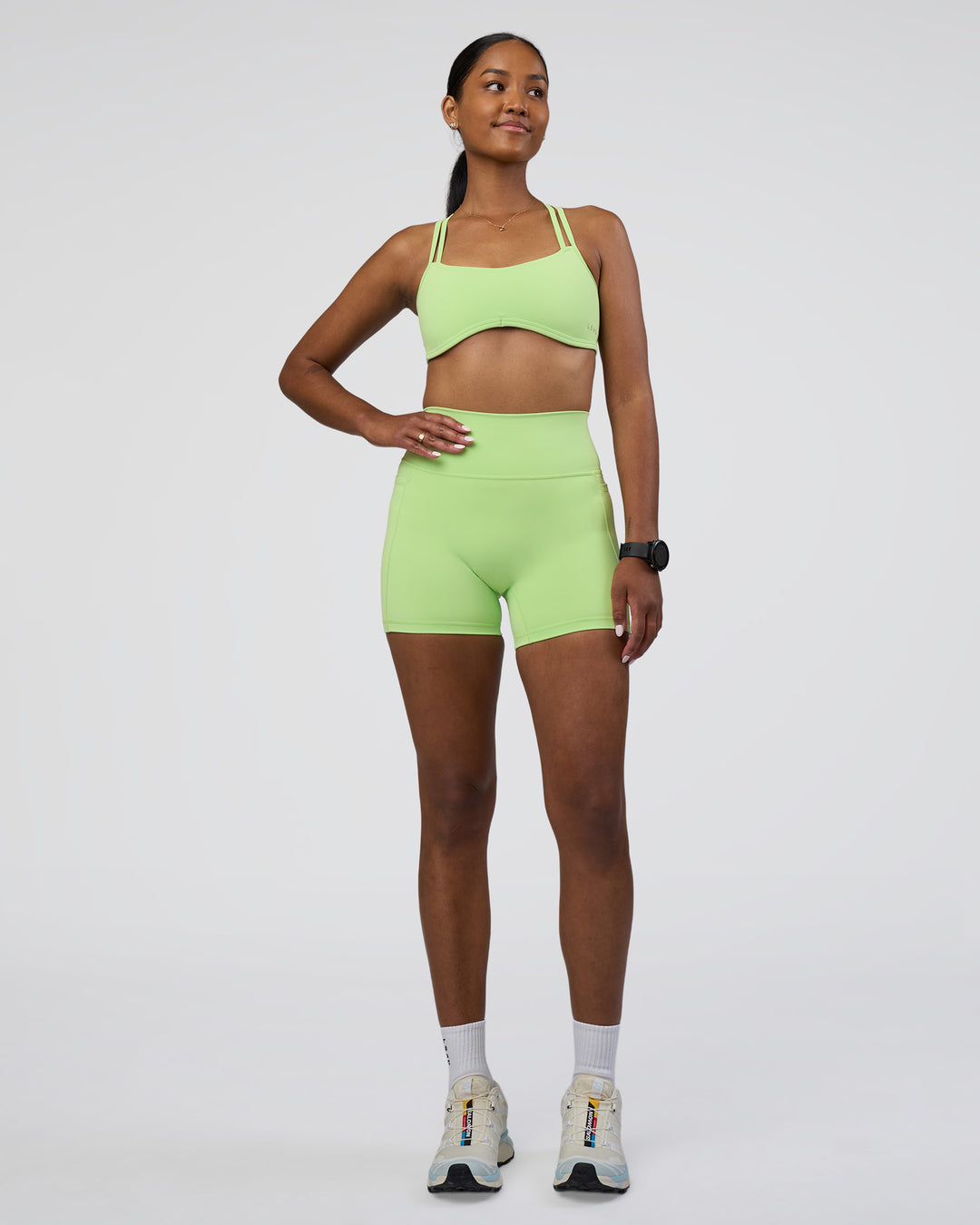 Woman wearing Interstellar Sports Bra - Solar Lime | Model:Rica | Size:S