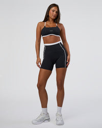 Woman wearing Liberate Contrast High-Rise 6" Short Pockets - Black-White | Model:Bianca | Size:S