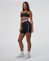 Woman wearing Liberate Contrast High-Rise 6" Short Pockets - Black-White | Model:Bianca | Size:S