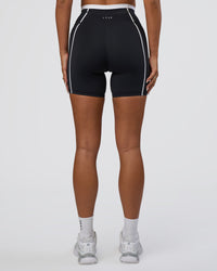 Woman wearing Liberate Contrast High-Rise 6" Short Pockets - Black-White | Model:Bianca | Size:S
