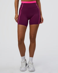 Woman wearing Liberate Contrast High-Rise 6" Short Pockets - Plum Caspia-Ultra Pink | Model:Bianca | Size:S