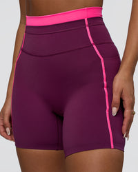 Woman wearing Liberate Contrast High-Rise 6" Short Pockets - Plum Caspia-Ultra Pink | Model:Bianca | Size:S