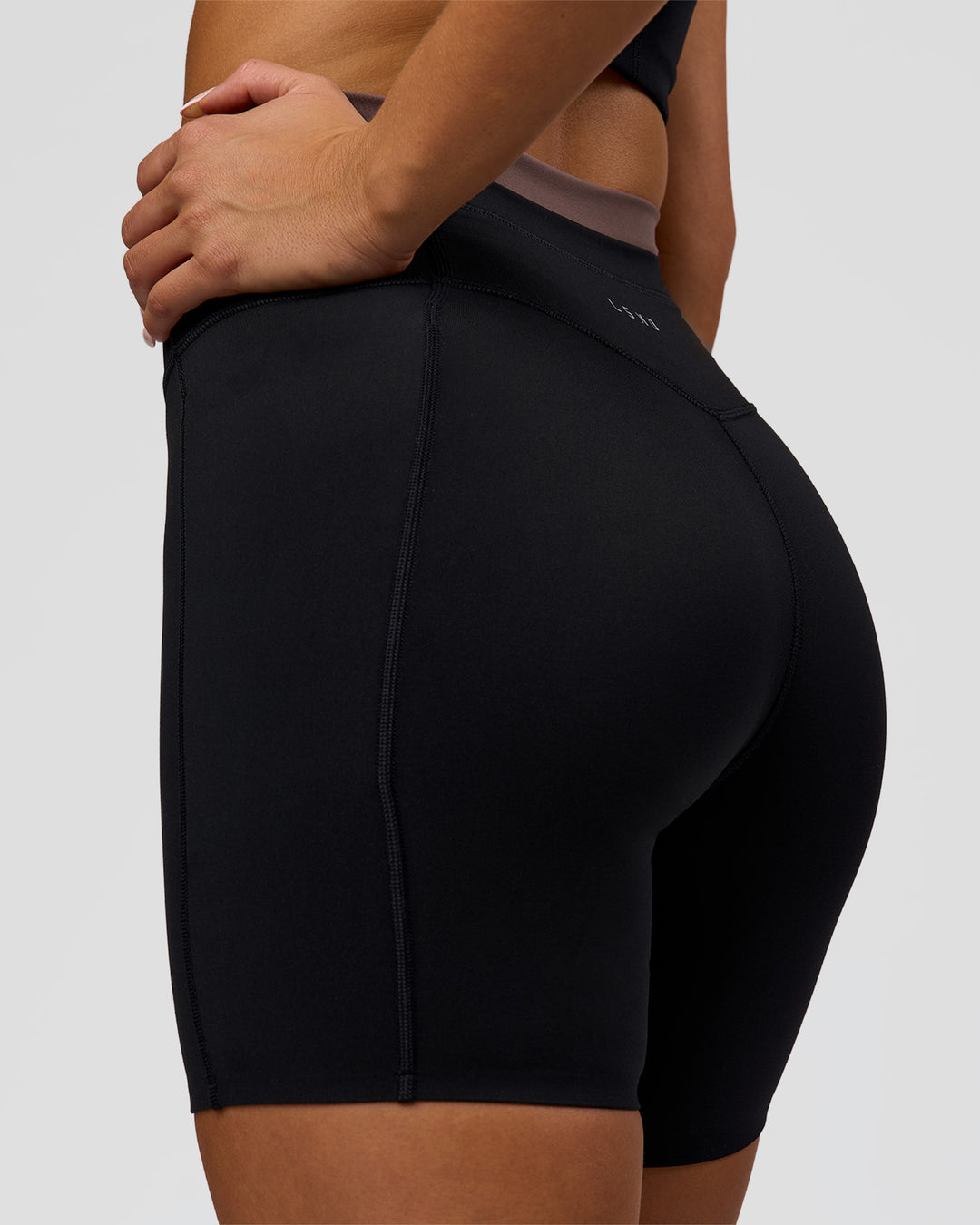 Woman wearing Liberate High-Rise 6" Short Pockets in Black-Cocoa Powder | Model:Bianca | Size:S - view 2