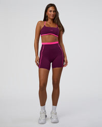 Woman wearing Liberate Sports Bra - Plum Caspia-Ultra Pink | Model:Bianca | Size:S