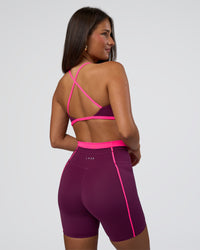 Woman wearing Liberate Sports Bra - Plum Caspia-Ultra Pink | Model:Bianca | Size:S