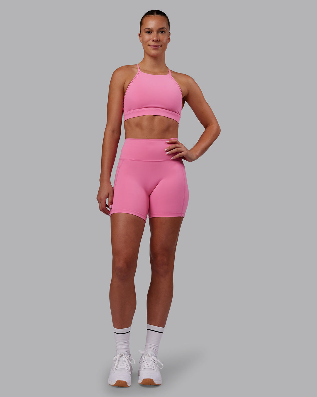 Woman wearing Lift High Neck Sports Bra - Candy Pink | Model:Charlize | Size:S