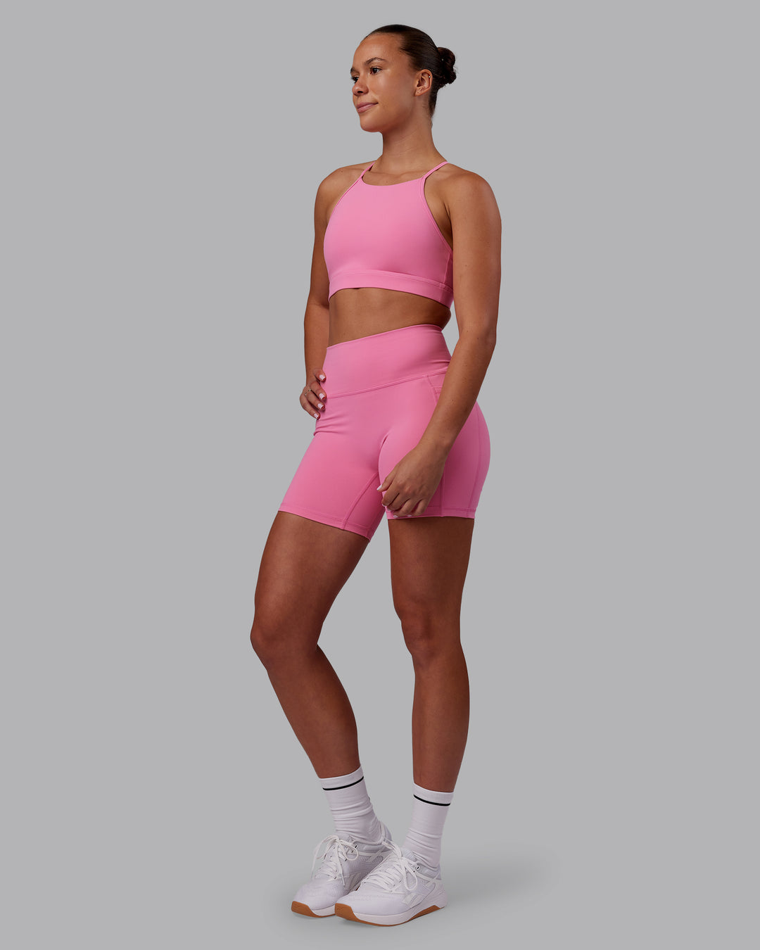 Woman wearing Lift High Neck Sports Bra - Candy Pink | Model:Charlize | Size:S