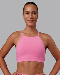 Woman wearing Lift High Neck Sports Bra - Candy Pink | Model:Charlize | Size:S