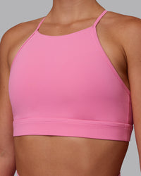 Woman wearing Lift High Neck Sports Bra - Candy Pink | Model:Charlize | Size:S