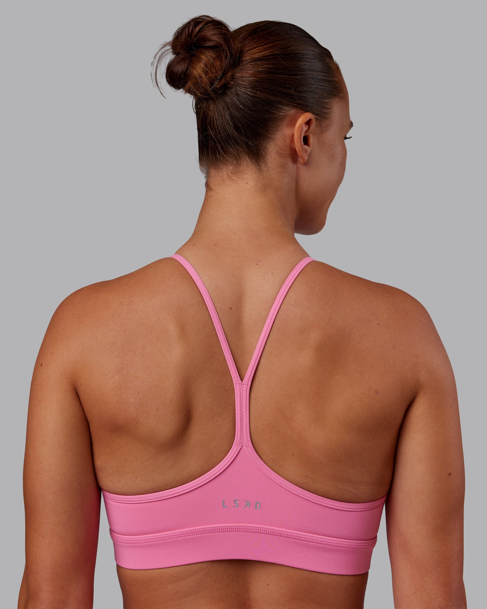 Woman wearing Lift High Neck Sports Bra - Candy Pink | Model:Charlize | Size:S