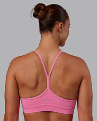 Woman wearing Lift High Neck Sports Bra - Candy Pink | Model:Charlize | Size:S