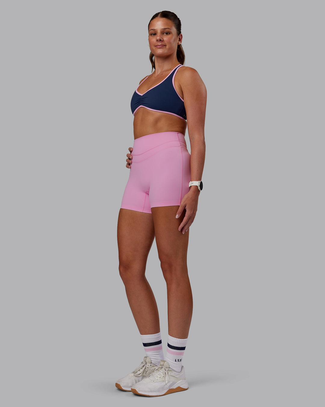 Woman wearing Love Her Wild Sports Bra - Future Navy-Pink Frosting | Model:Phoebe | Size:S