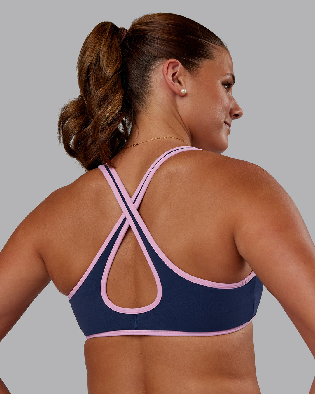 Woman wearing Love Her Wild Sports Bra - Future Navy-Pink Frosting | Model:Phoebe | Size:S