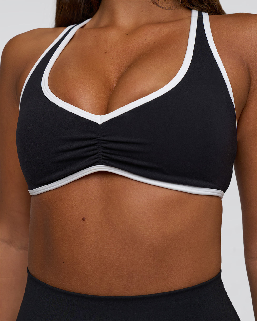 Woman wearing Luminous Sports Bra - Black-White | Model:Bianca | Size:S