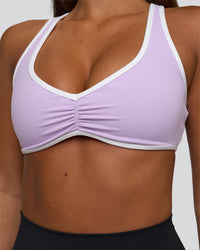 Woman wearing Luminous Sports Bra - Pale Lilac-White | Model:Bianca | Size:S