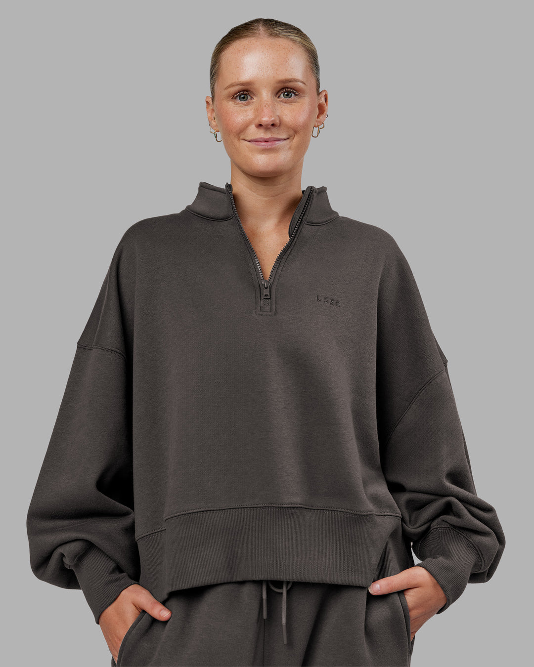 Woman wearing MVP 1/2 Zip Oversized Sweater - Dark Storm | Model:Neve | Size:Dark Storm