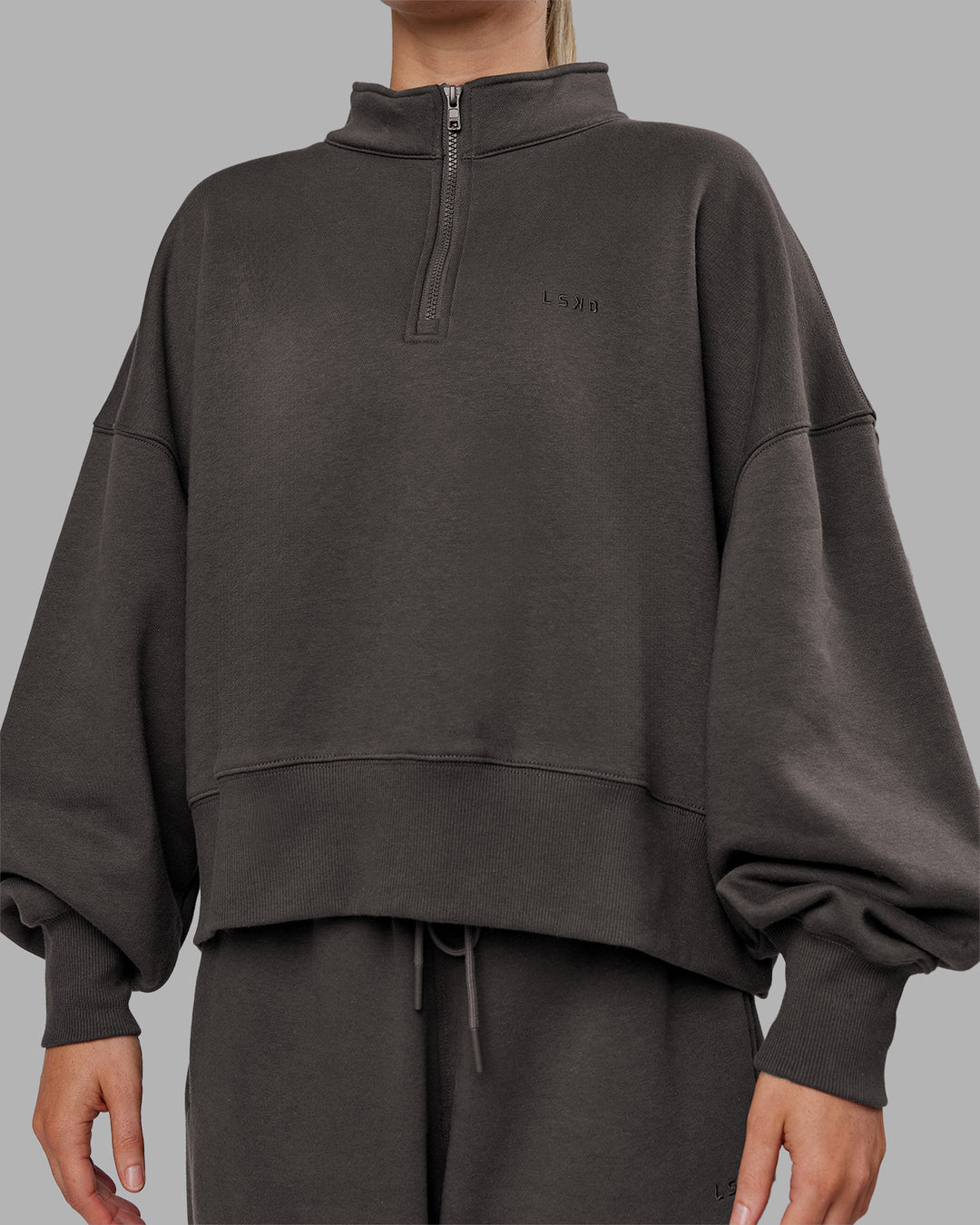 Woman wearing MVP 1/2 Zip Oversized Sweater - Dark Storm | Model:Neve | Size:Dark Storm