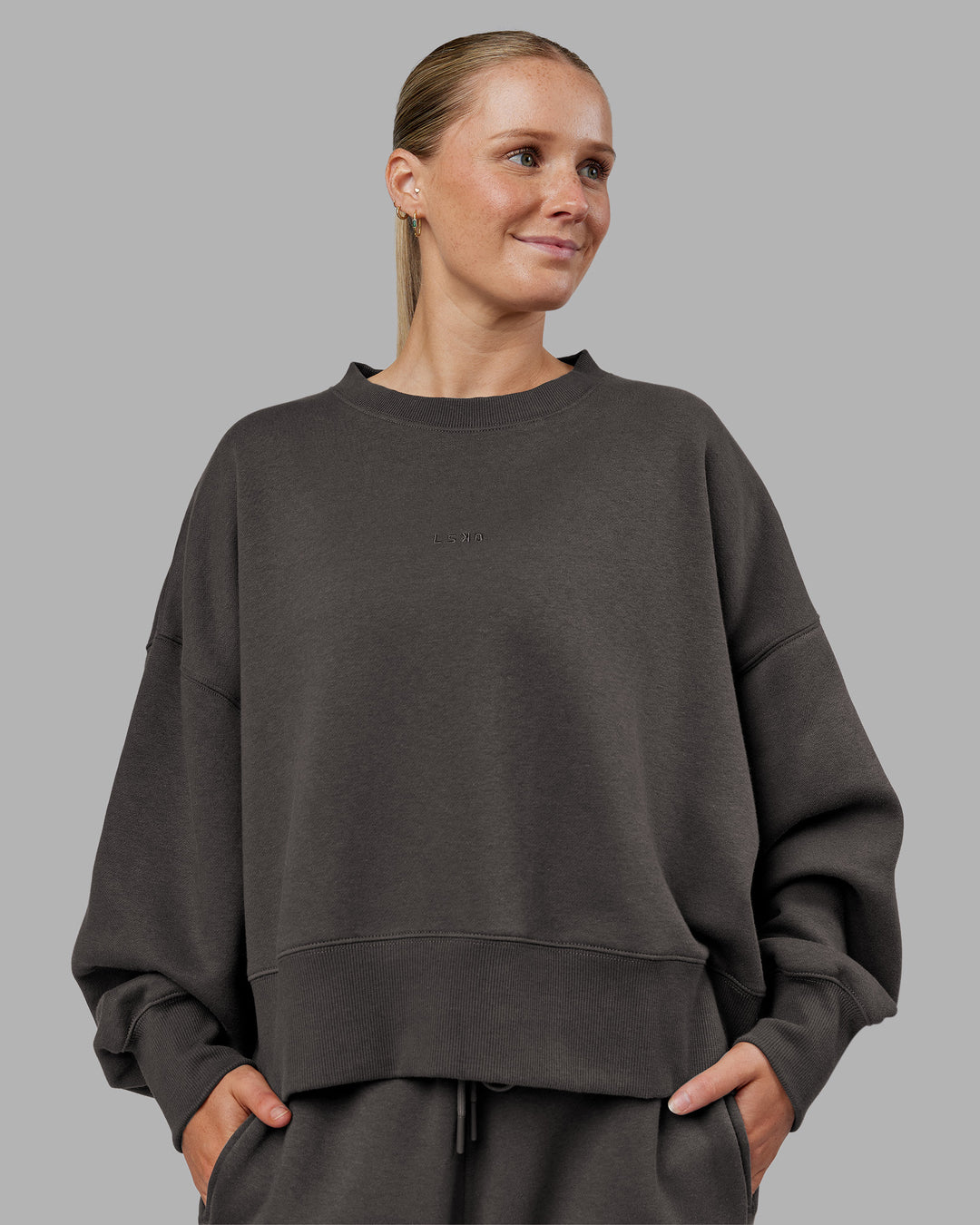 Woman wearing MVP Oversized Sweater - Dark Storm | Model:Neve | Size:S