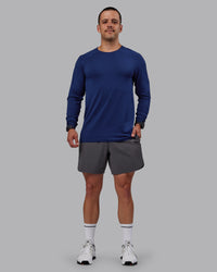Man wearing AeroFLX+ Seamless Long Sleeve Tee - Midnight Blue/Midnight Blue Marl