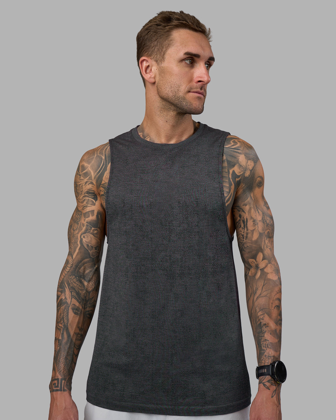 Man wearing AeroFLX+ Seamless Muscle Tank - Black Camo-Graphite | Model:Tommy | Size:S