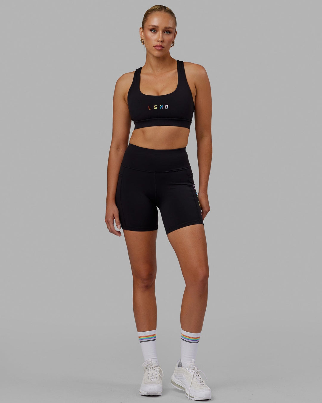 Woman wearing Rep Mid Short Tight - Pride-Black