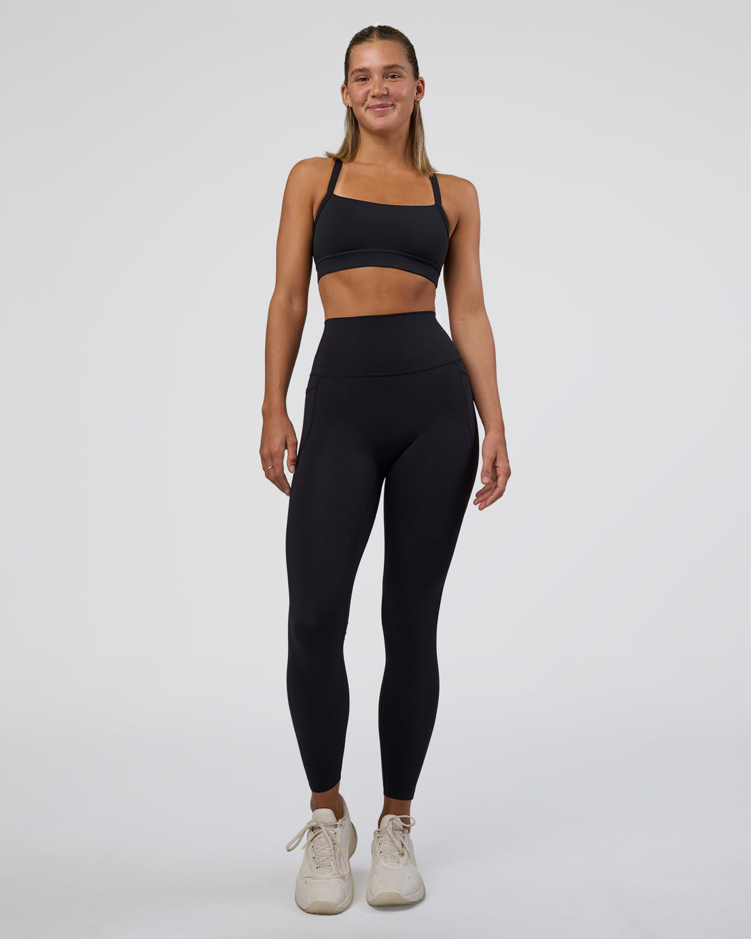 Woman wearing Momentum Sports Bra - Black | Model:Amity | Size:S