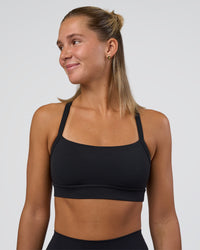 Woman wearing Momentum Sports Bra - Black | Model:Amity | Size:S