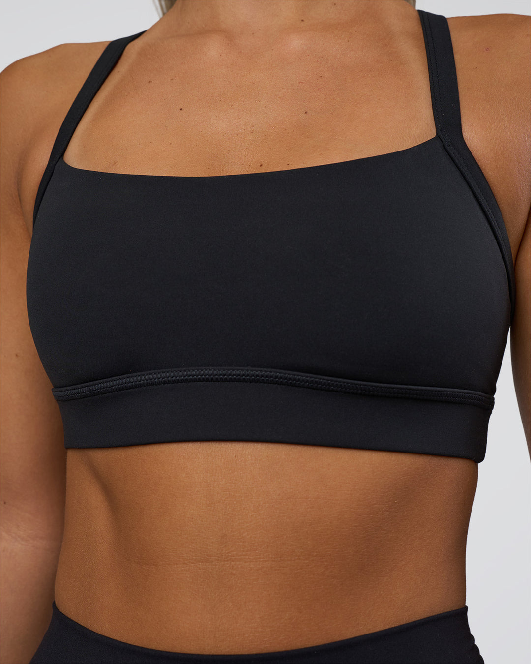 Woman wearing Momentum Sports Bra - Black | Model:Amity | Size:S