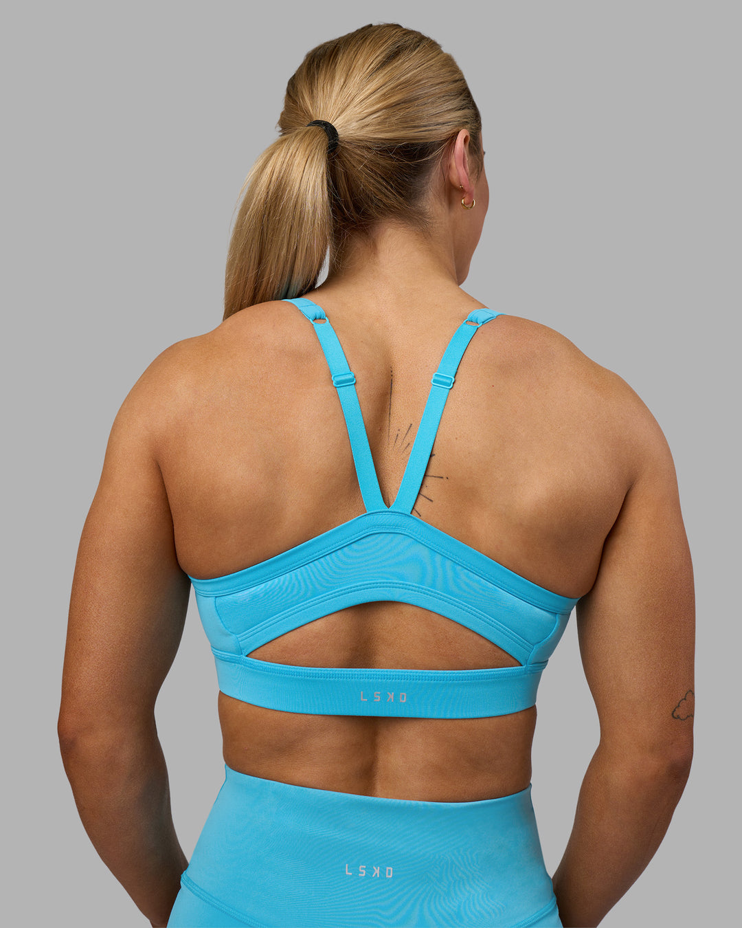 Woman wearing Momentum Sports Bra - Blue Atoll | Model:Georgia | Size:S