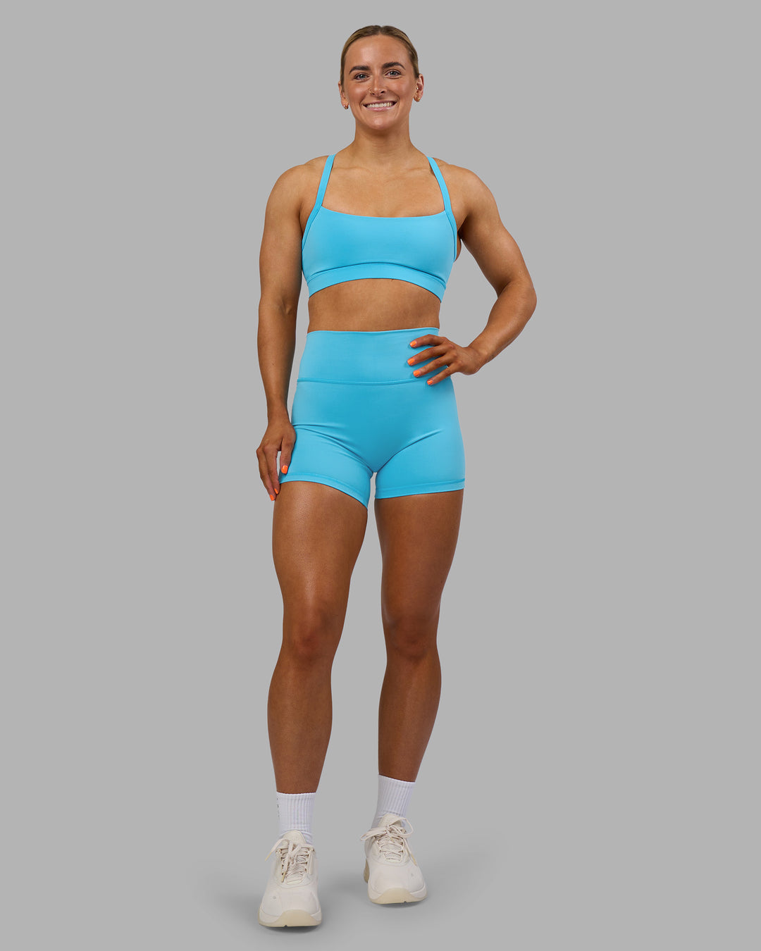 Woman wearing Momentum Sports Bra - Blue Atoll | Model:Georgia | Size:S