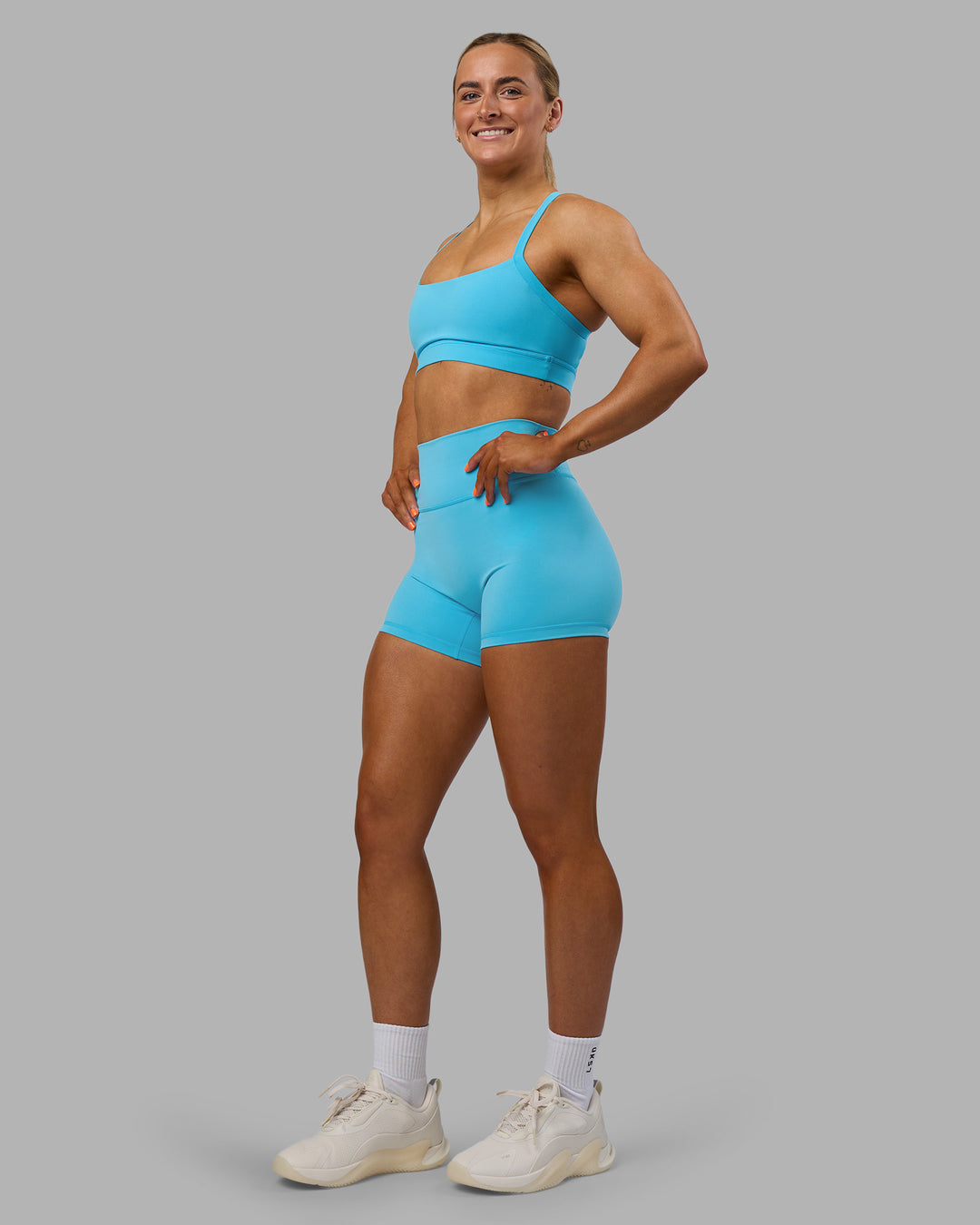 Woman wearing Momentum Sports Bra - Blue Atoll | Model:Georgia | Size:S