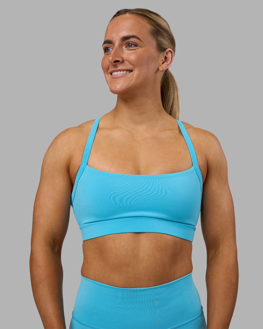 Woman wearing Momentum Sports Bra - Blue Atoll | Model:Georgia | Size:S