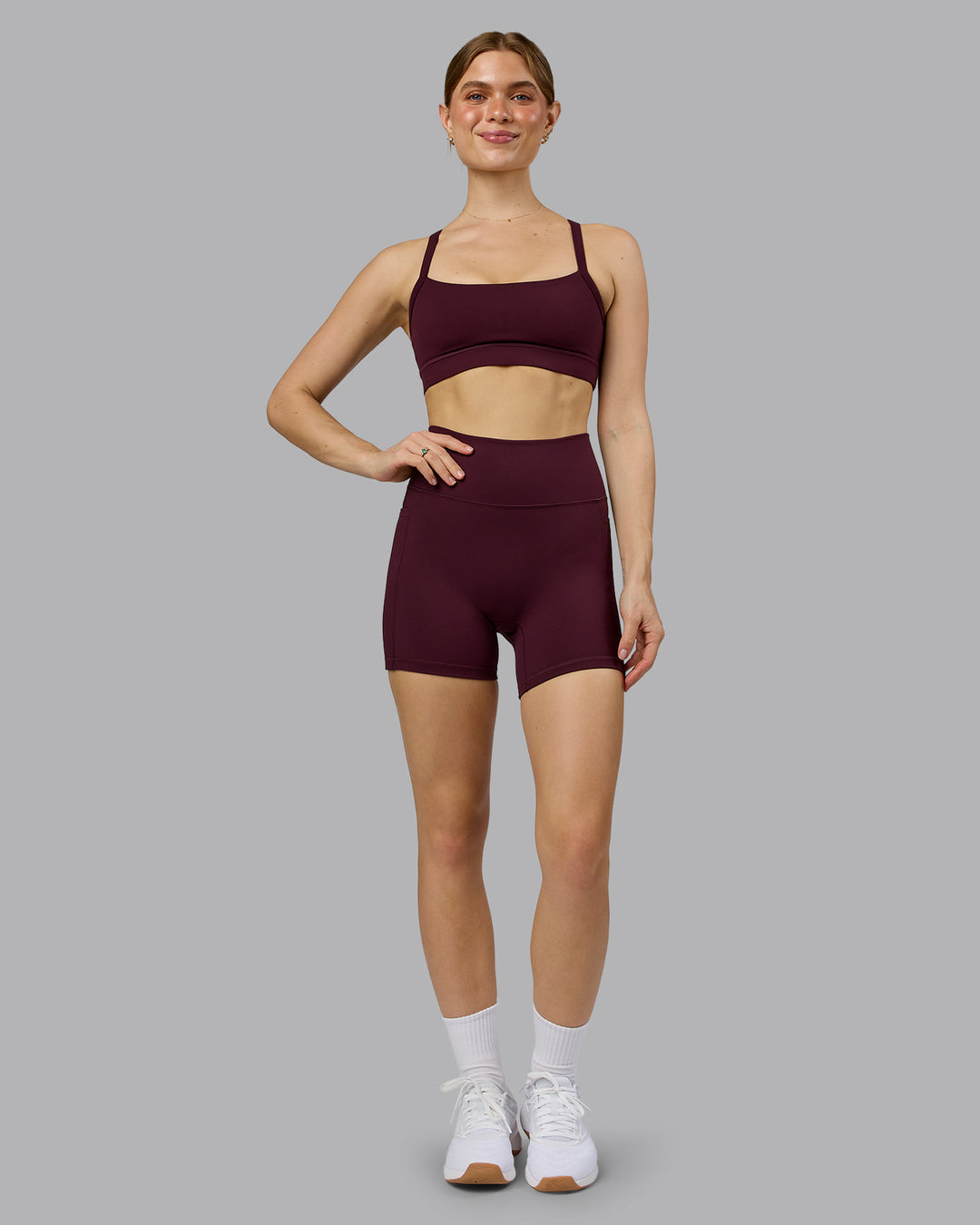 Woman wearing Momentum Sports Bra - Cherry Lacquer | Model:Emilie | Size:S