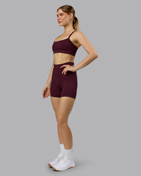 Woman wearing Momentum Sports Bra - Cherry Lacquer | Model:Emilie | Size:S