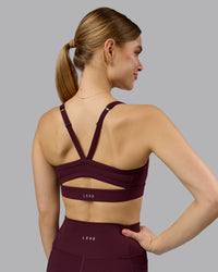 Woman wearing Momentum Sports Bra - Cherry Lacquer | Model:Emilie | Size:S