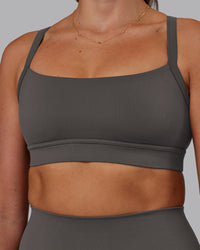 Woman wearing Momentum Sports Bra - Dark Storm | Model:Phoebe | Size:S