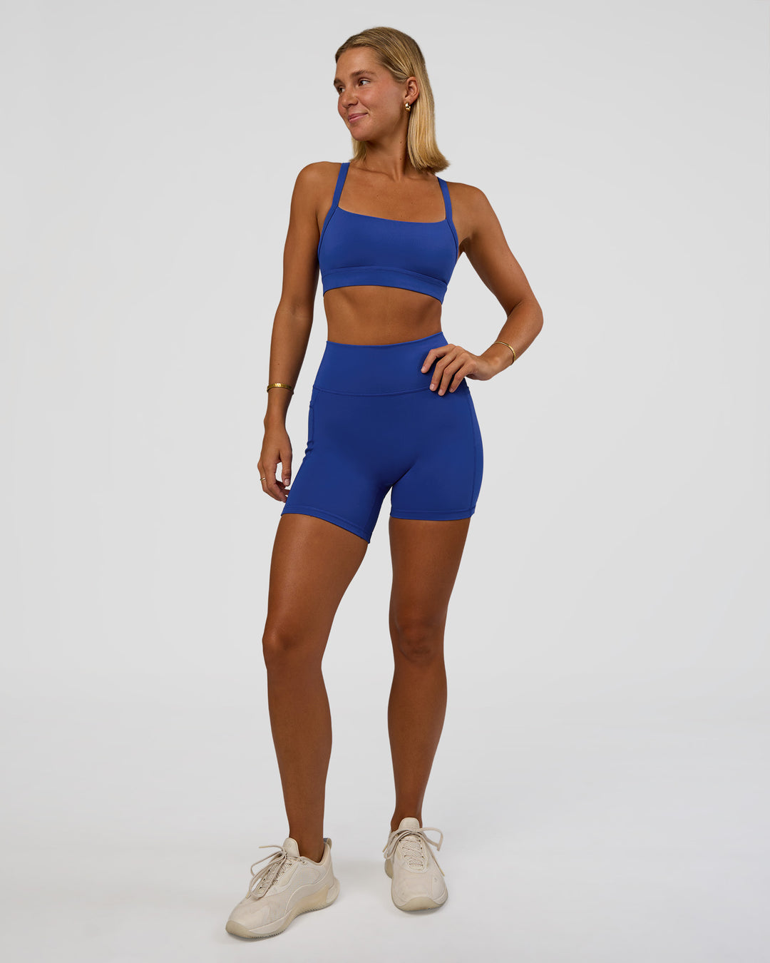 Woman wearing Momentum Sports Bra - Electric Indigo | Model:Amity | Size:S