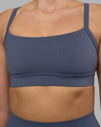 Woman wearing Momentum Sports Bra - Night Shadow | Model:Phoebe | Size:S