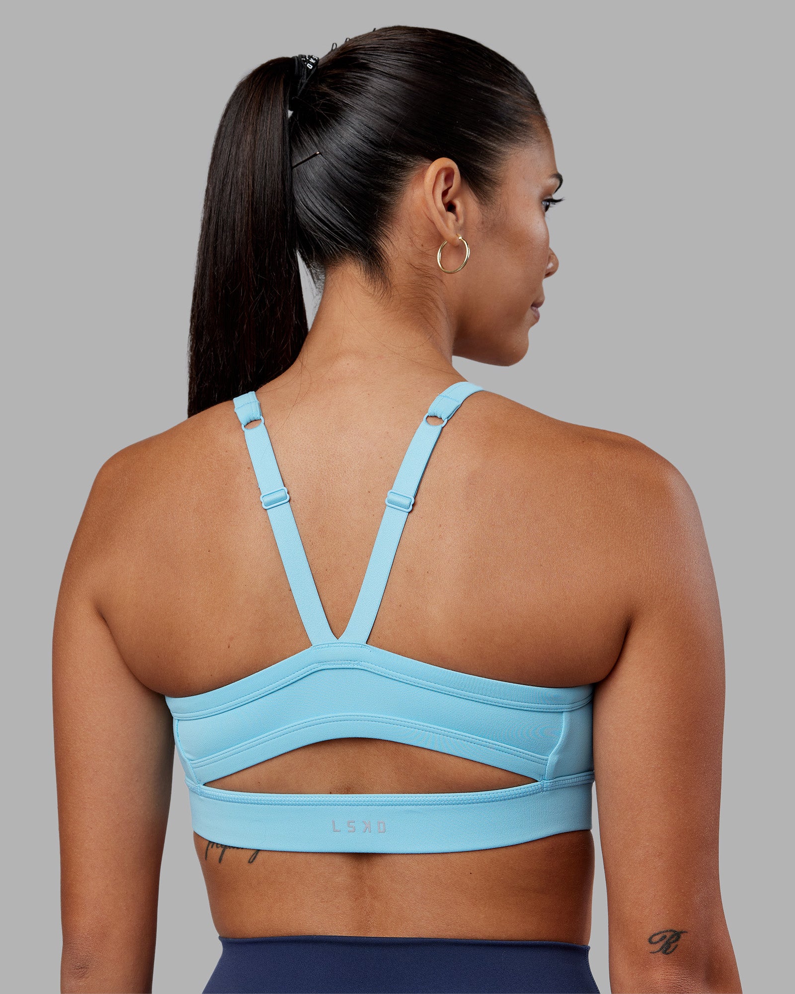 Woman wearing Momentum Sports Bra - Sky Blue | Model:Rhiley | Size:S