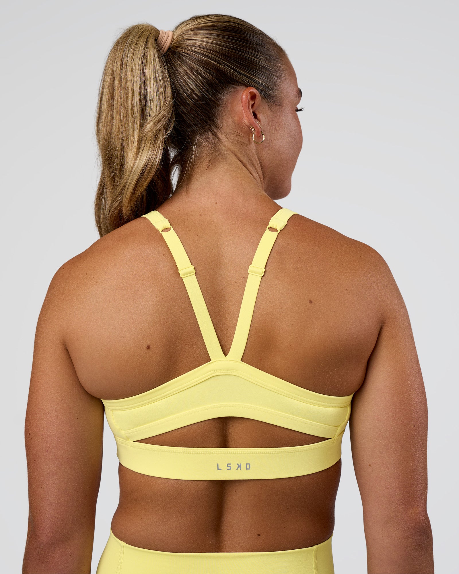 Woman wearing Momentum Sports Bra - Yellow Fizz | Model:Sav | Size:S