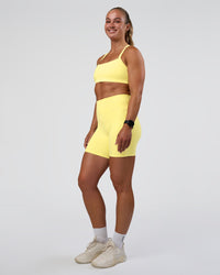 Woman wearing Momentum Sports Bra - Yellow Fizz | Model:Sav | Size:S