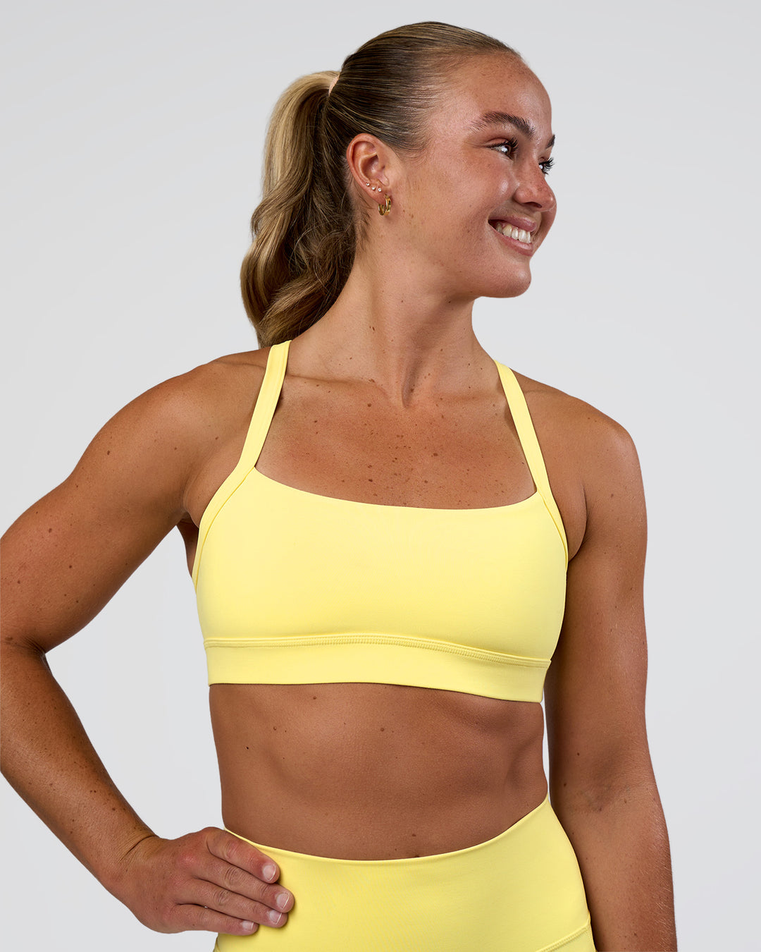 Woman wearing Momentum Sports Bra - Yellow Fizz | Model:Sav | Size:S