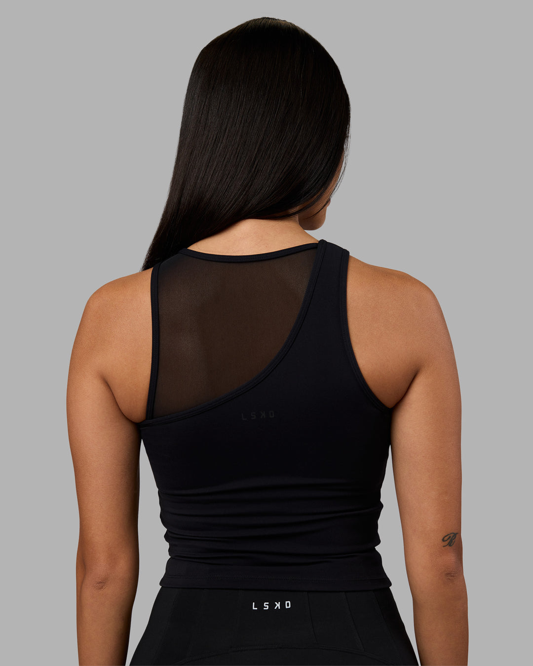 Woman wearing Motion Mesh Shelf Bra Tank - Black | Model:Rhiley | Size:S