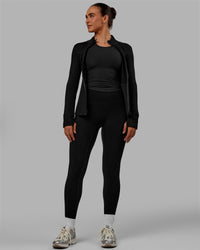Woman wearing Motion Ultra High-Rise Thermal Full Length Legging - Black