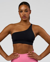 Woman wearing Muse Asymmetric Sports bra - Black | Model:Rosie | Size:S