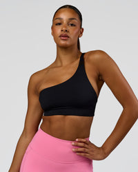 Woman wearing Muse Asymmetric Sports bra - Black | Model:Rosie | Size:S