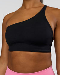 Woman wearing Muse Asymmetric Sports bra - Black | Model:Rosie | Size:S