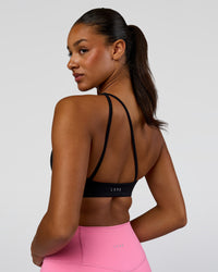 Woman wearing Muse Asymmetric Sports bra - Black | Model:Rosie | Size:S