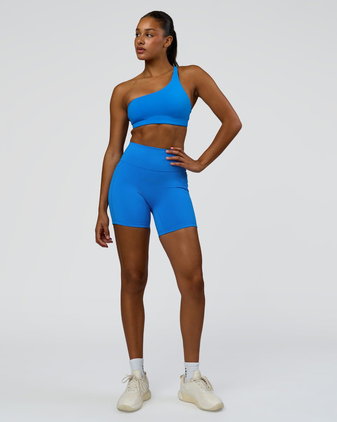 Woman wearing Muse Asymmetric Sports bra - Palace Blue | Model:Rosie | Size:S - view 3